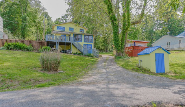 Cozy lakefront retreat with private dock, scenic views, updated interiors and serene outdoor seating in Hiwassee