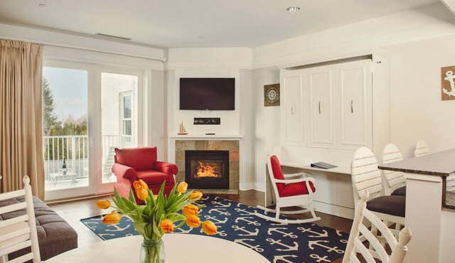 Experience luxury at Captain Suite 219 in Bay Harbor, MI, featuring a cozy bedroom and village view. in Bay Harbor